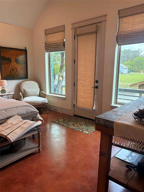 This home has a large primary bedroom on the first floor. The large windows and vaulted ceiling make this room a peaceful retreat. Waking up to lake views and walking out to your back deck make this home a true lake house.