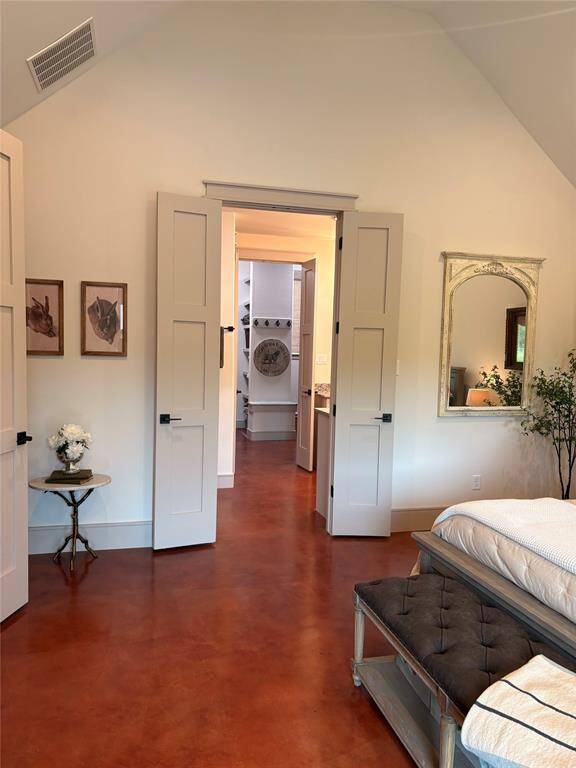 Another view of this large primary bedroom. This bedroom in ensuite with a two vanities, private toilet area, and large walk in shower. Past the bathroom you have an enmorous walk in closet.