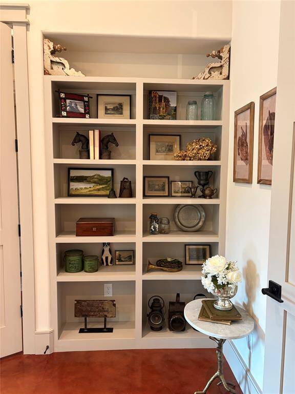 More custom woodwork in the primary bedroom. Beautiful shelving adds an extra touch.
