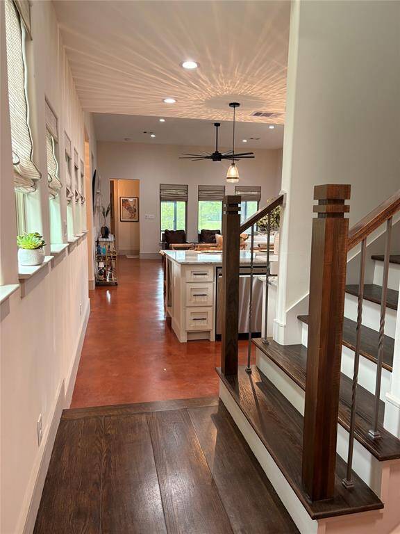 Here's the view when you walk in the door from the garage. To the right is a cubby area/drop zone. You also see the stairs leading to the second story. The craftsman woodwork is continued up the stairwell with pretty newel posts, iron spindles, and wood stair treads.