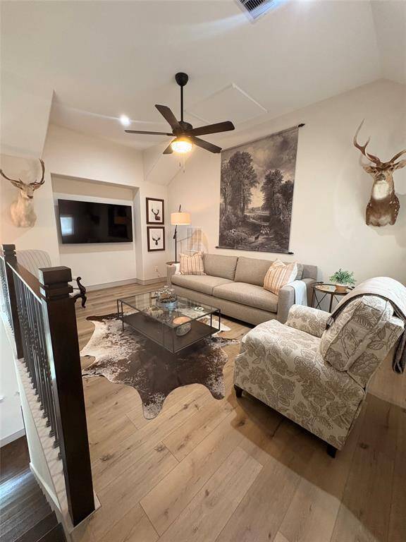 Throughout the upstairs is a pretty LVP flooring. The second floor also has large bright windows, neutral paint, ceiling fans, and high ceilings.