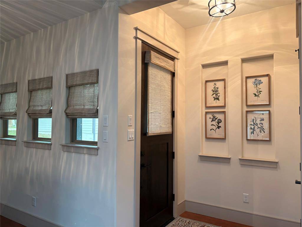 This is the front entry off the pretty walkway leading up to the house. Soft neutral paint is throughout the house. This pretty Craftsman home was designed with hand crafted details, custom woodwork, earth toned colors, and large windows that let in natrure's beauty.
