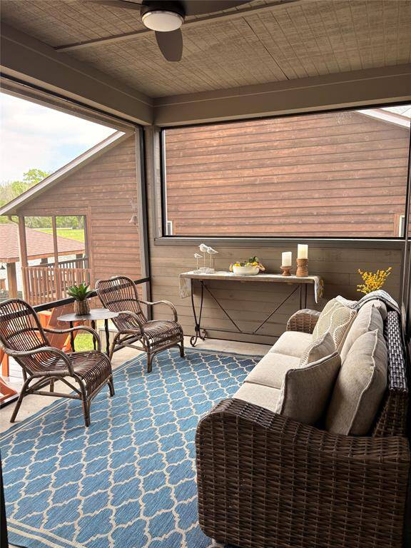 Off the main downstairs living area is a screened porch. The room overlooks the deck, yard, boathouse, and peaceful view of the lake.