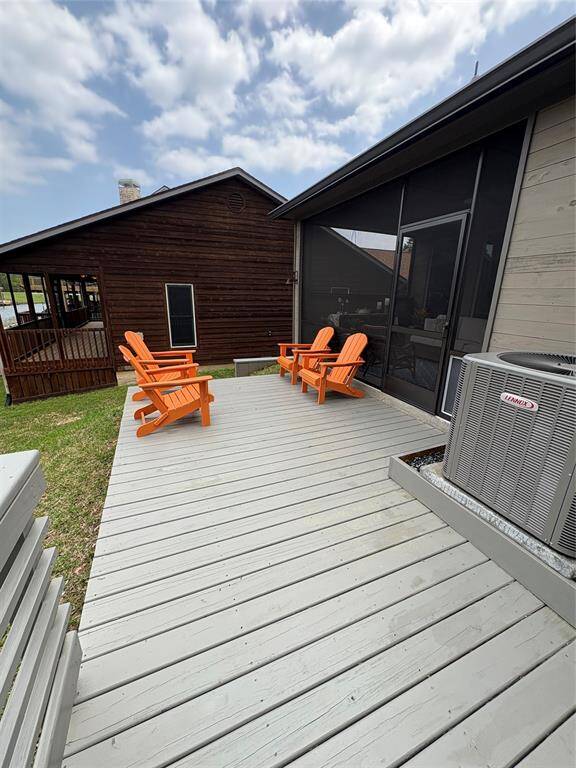 This home has two decks. One outside the screen porch and primary bedroom and one attached to the boathouse that's lakeside.
