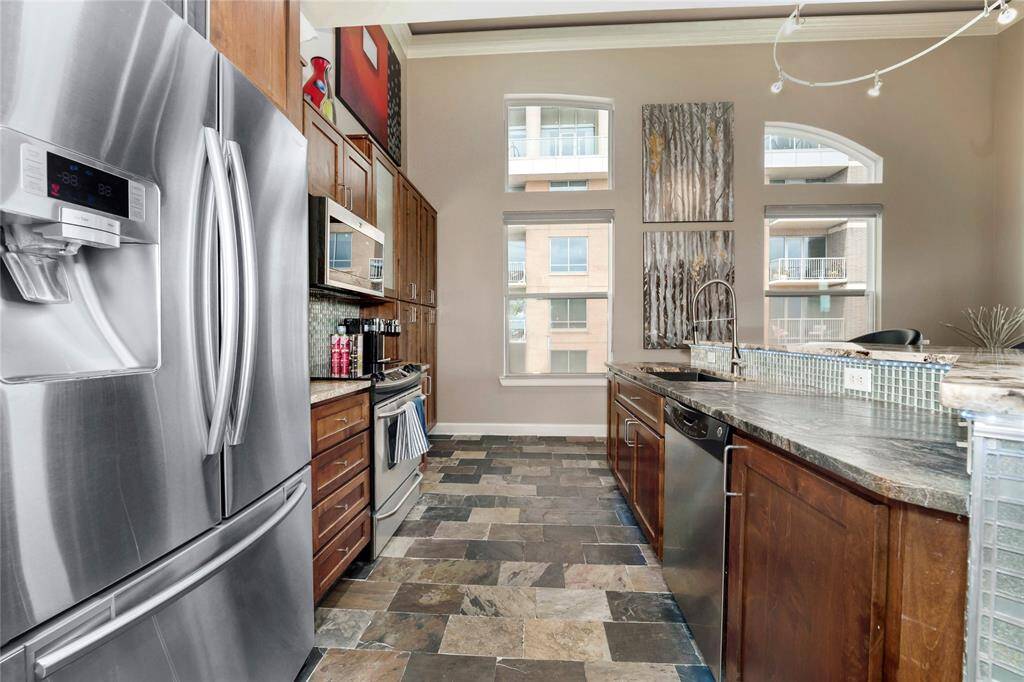 Closer look at the kitchen with ample storage and all stainless steel appliances.