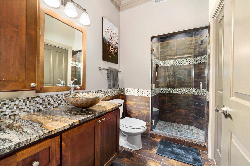 A look at the hallway bathroom with a stand-up shower. Washer and dryer is located in the closet just to the right in this hallway bath.