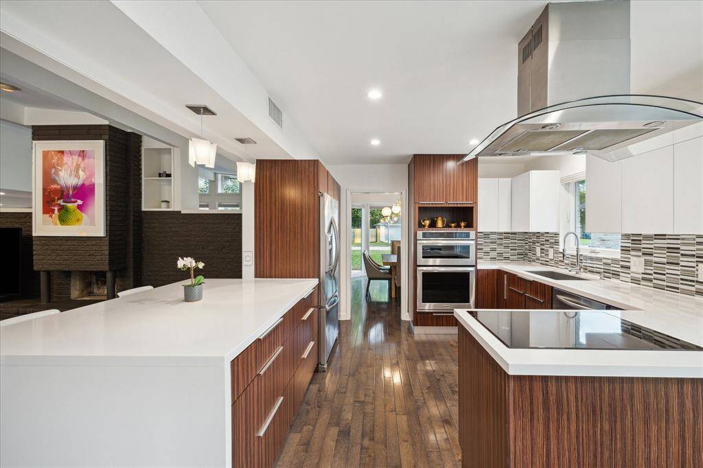 KitchenAid stainless steel appliances and Silestone counters are featured in this sleek modern kitchen