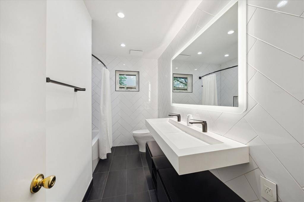 In 2021 the hall bath was remodeled with sleek modern fixtures, floating cabinets