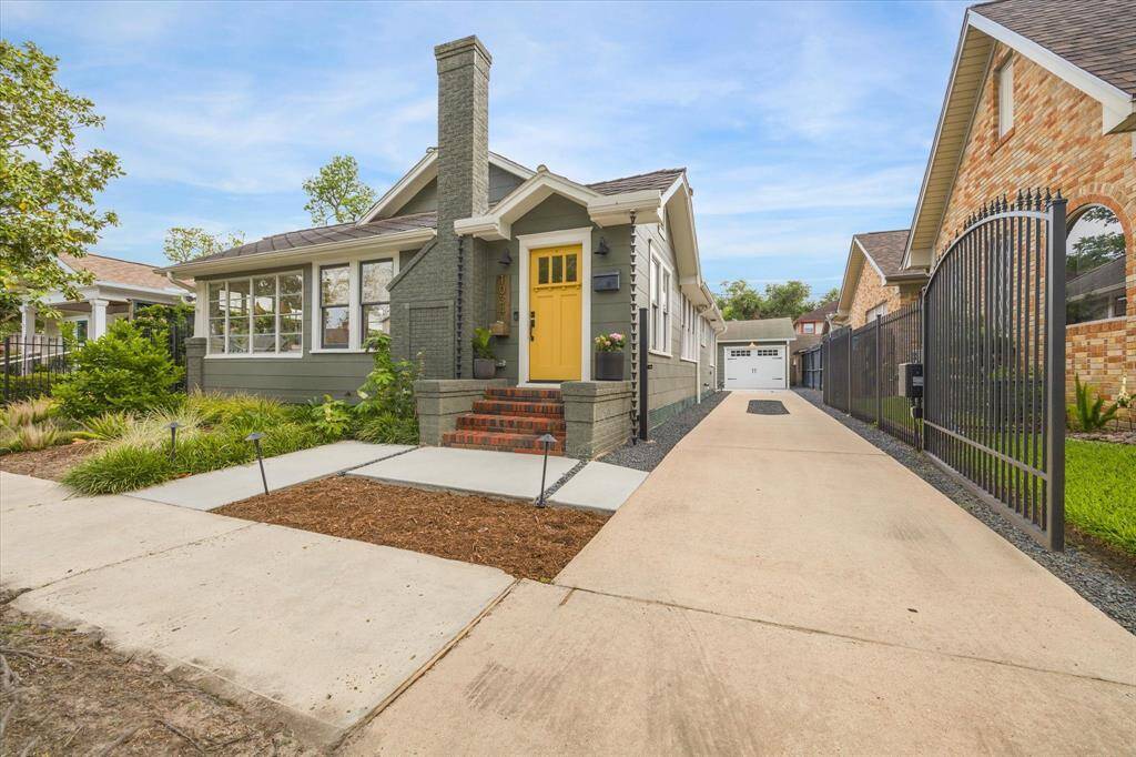 Long driveway with automatic gate leading to a detached garage.