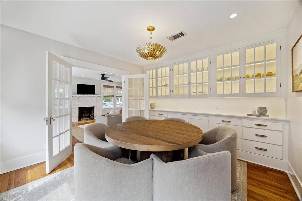 Another view of the dining room with beautiful lit cabinetry.