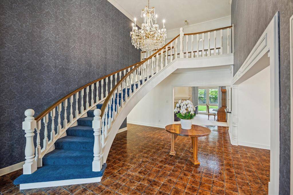 Important staircase in wide entry adjacent to dining room