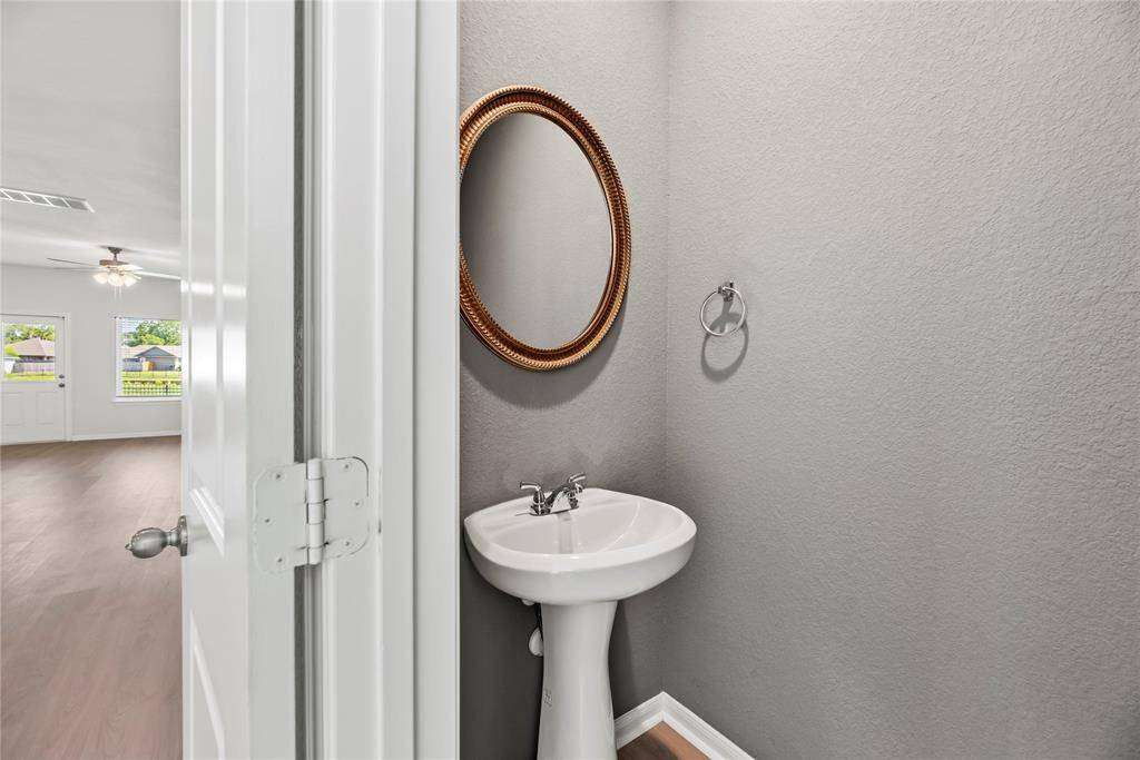 The half bath is located conveniently off the living room, perfect for guests.