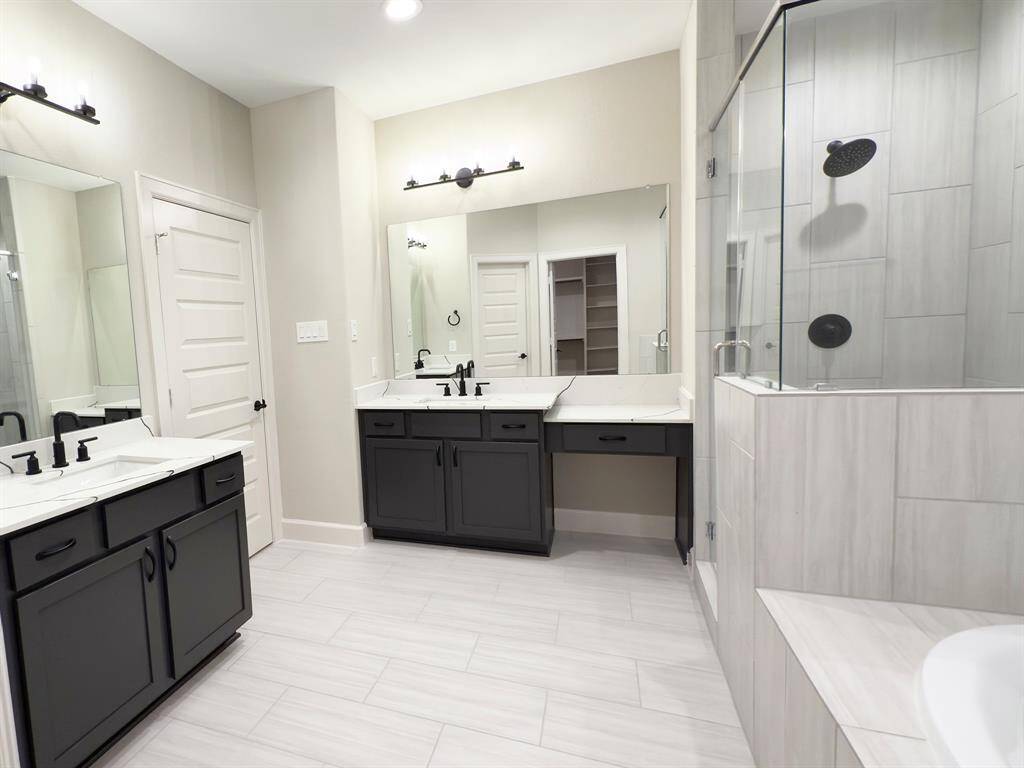 Whether you're starting your day or unwinding in the evening, the ROCburne’s primary bathroom is a private sanctuary where luxury meets everyday living. Image depicts home as is.