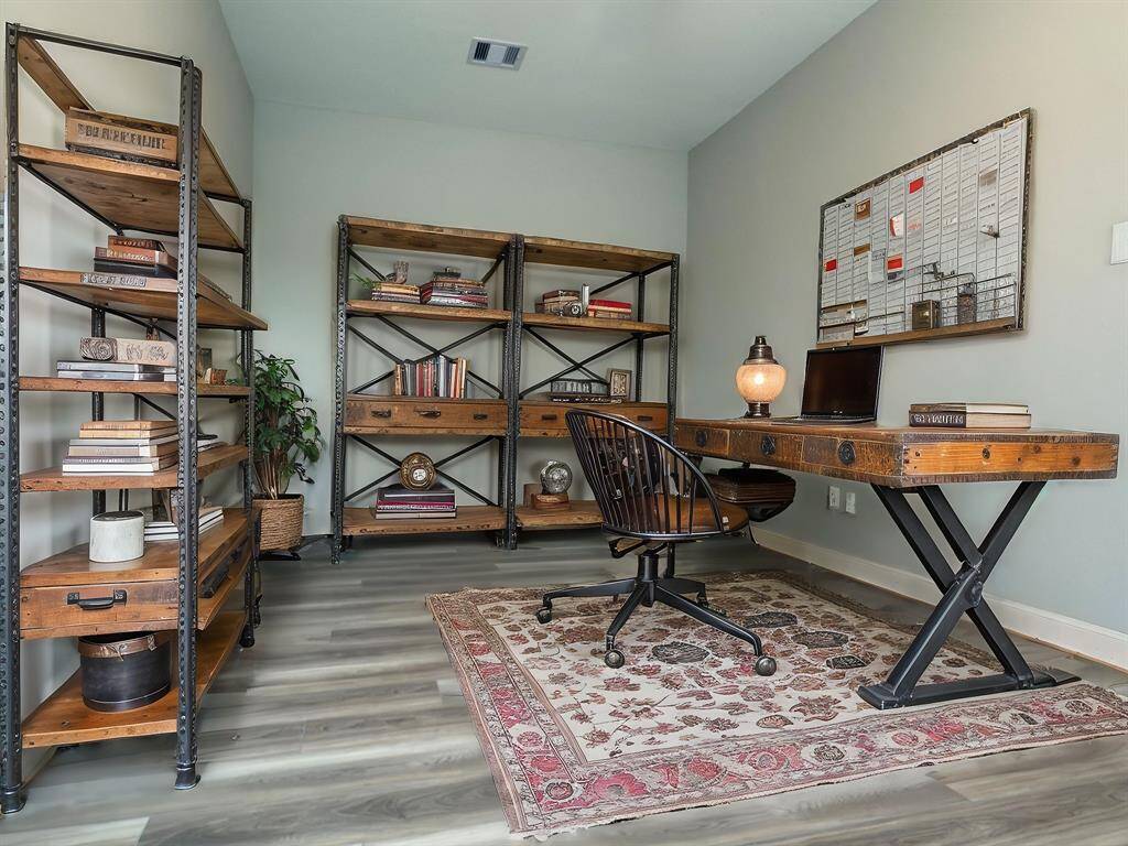The ROCburne's multi-use room is a versatile space designed to adapt to various needs, whether as a home office, entertainment area, or media room. Image depicts home as is virtually staged.