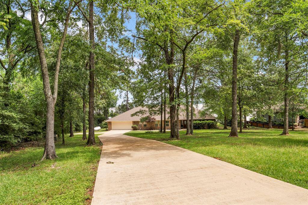 Beautiful mature trees create privacy and a serene front yard setting