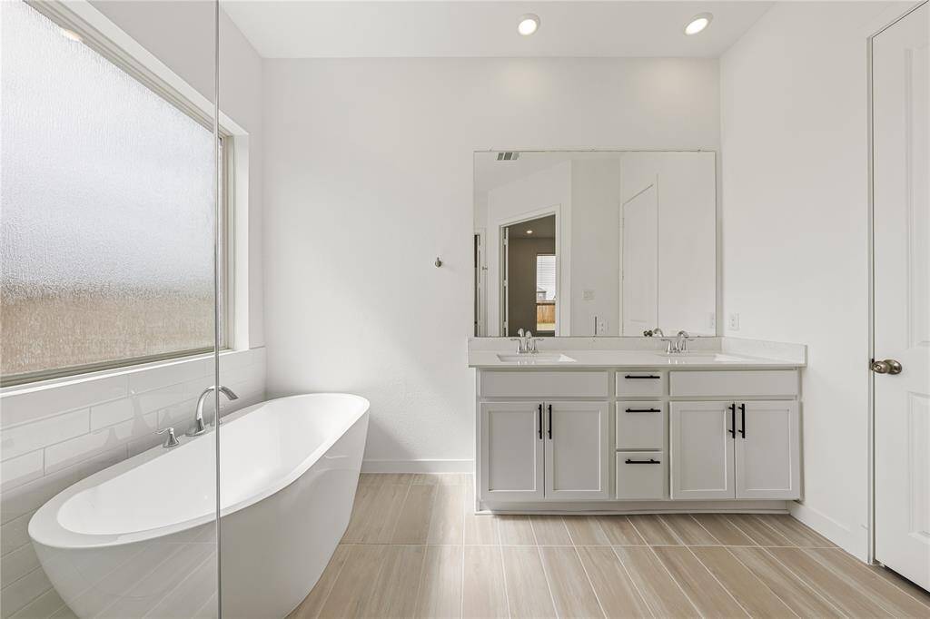 Primary bathroom with double sinks, shower and soaking tub