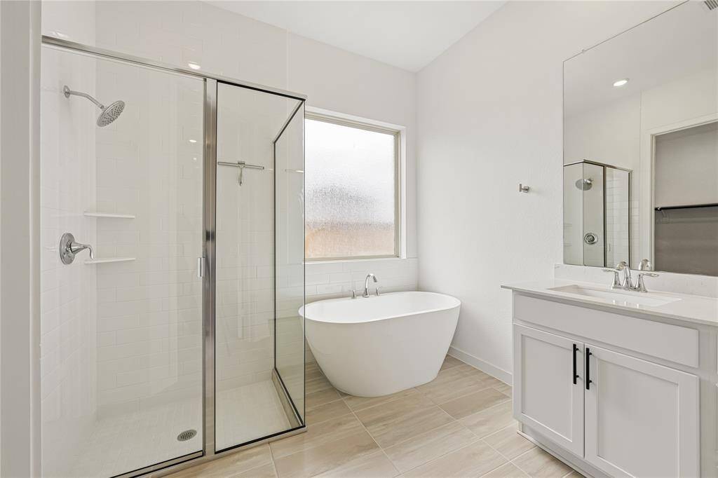 Primary bathroom with double sinks, shower and soaking tub