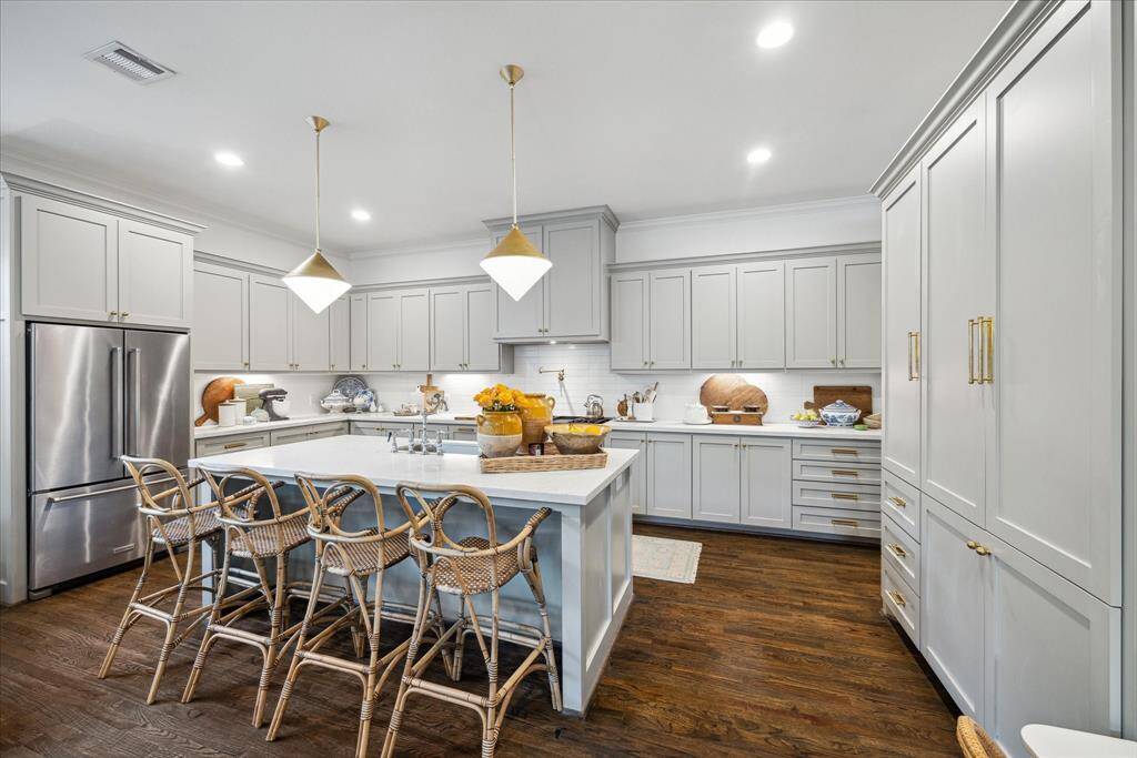 Indulge in the ultimate cooking experience in this exquisite kitchen, including a 48" Thermador range, a pot filler, a drawer microwave, custom on-site built cabinets that provide ample space for storage.