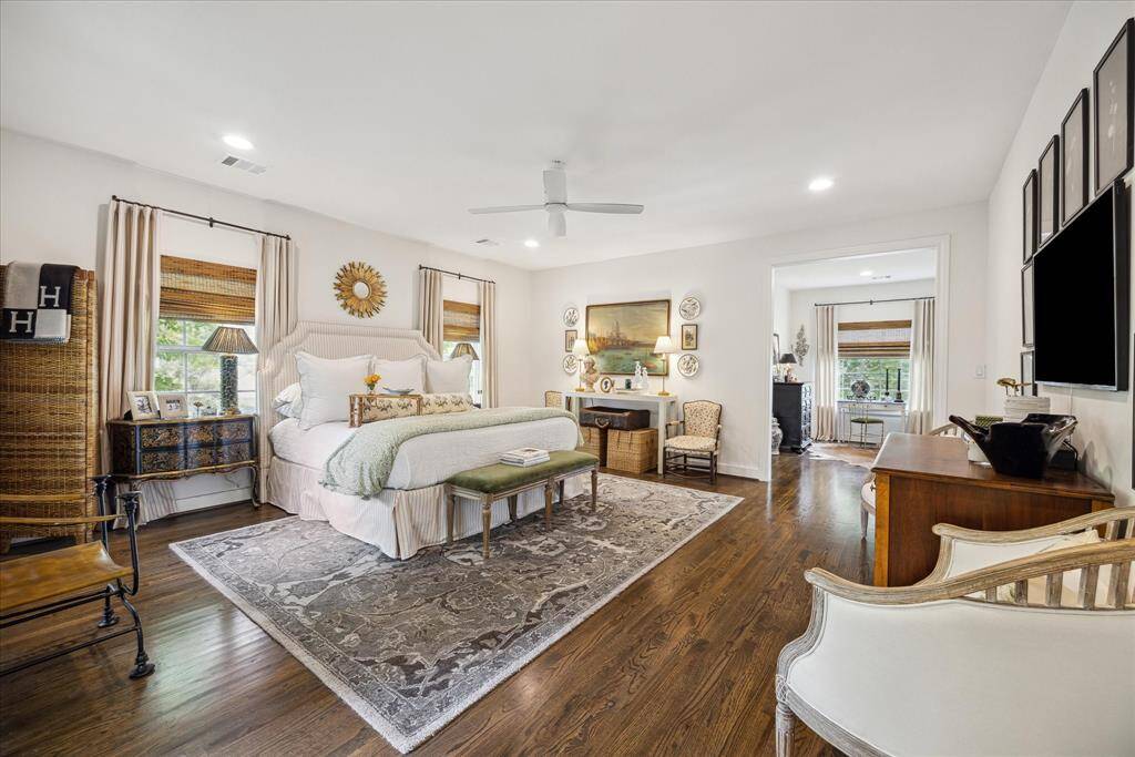 Welcome to this spacious primary bedroom with large windows that flood the room with natural light.
