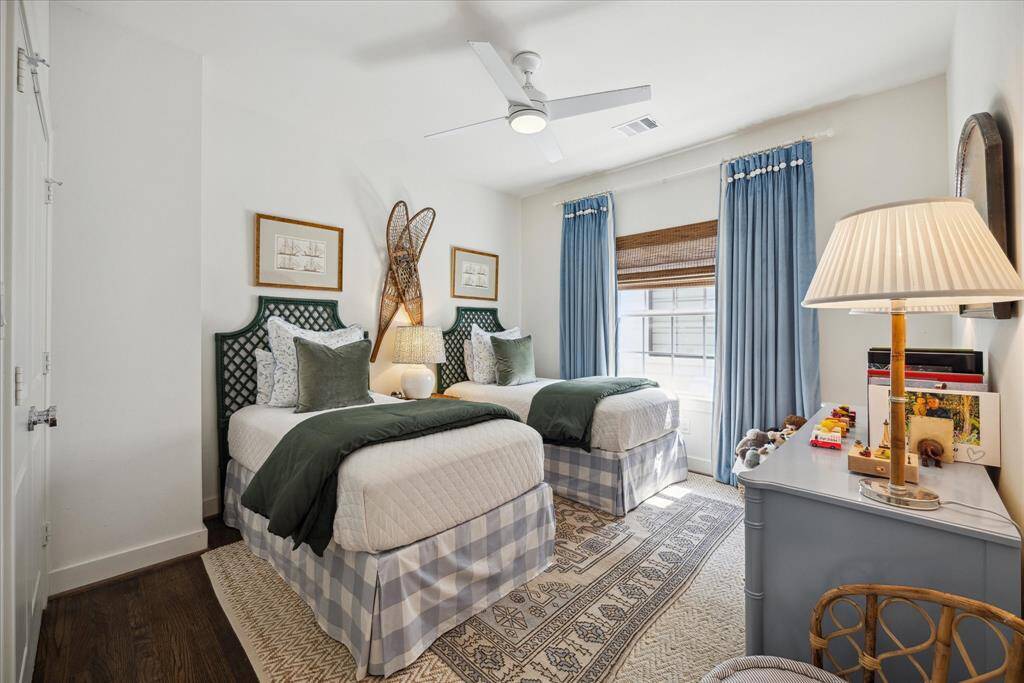 This bedroom exudes comfort, and the natural bamboo shades add an attractive touch.