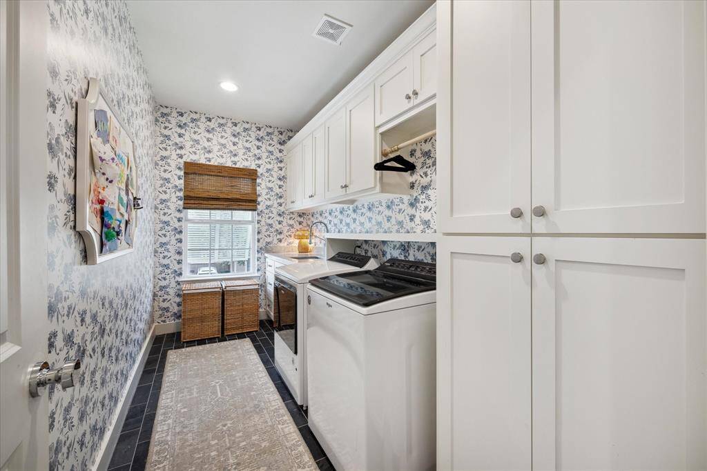 What’s not to love about the gorgeous, spacious and functional laundry room. It’s equipped with plenty of built-in cabinets for extra storage.