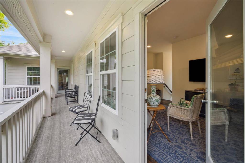 Enjoy an evening happy hour from the serenity of this wrap around balcony overlooking the yard below.