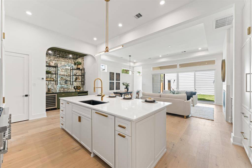 View of kitchen and wine bar with beautiful smoky mirror backsplash.