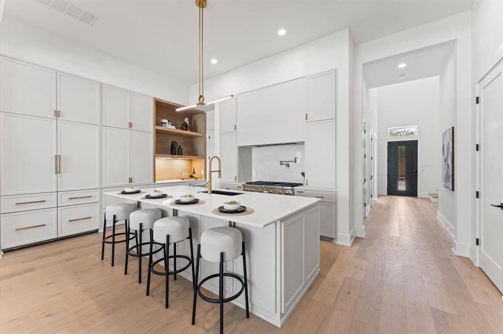 Kitchen boasts panel Thermador appliances.