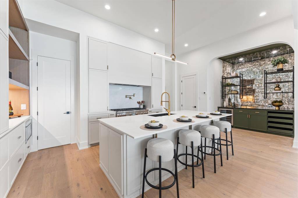 Kitchen is finished with Calacatta quartz countertops and backsplash.