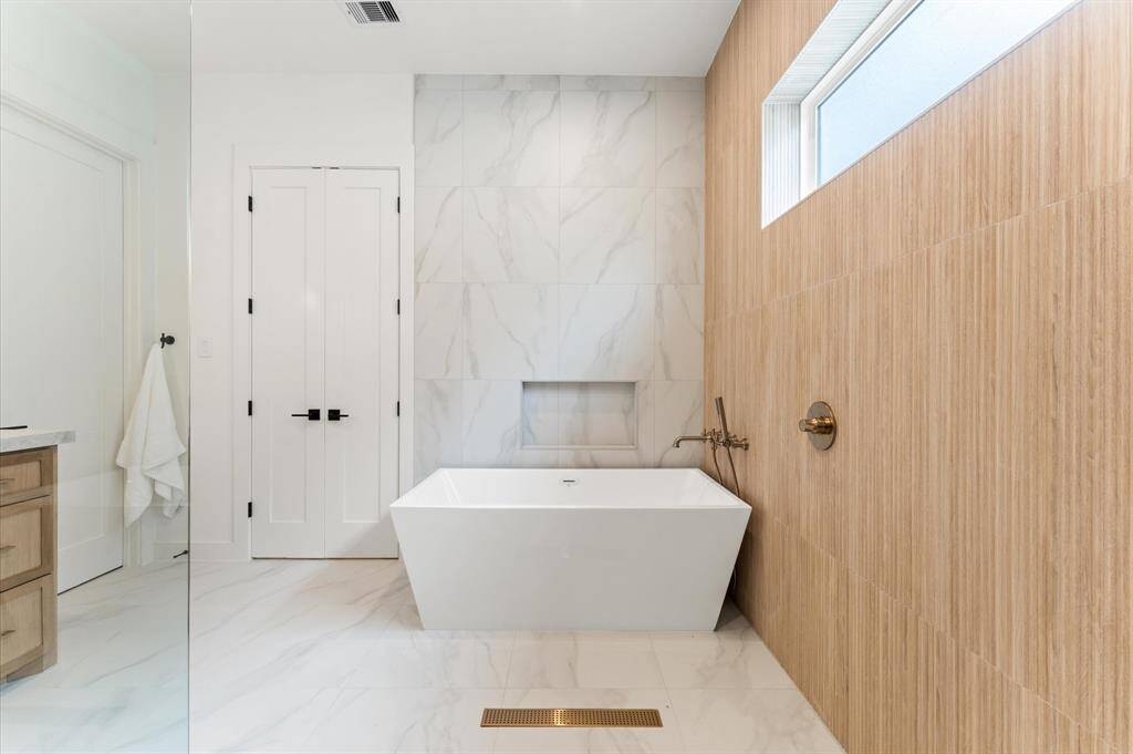 Primary bath has dual sinks and separate soaking tub.
