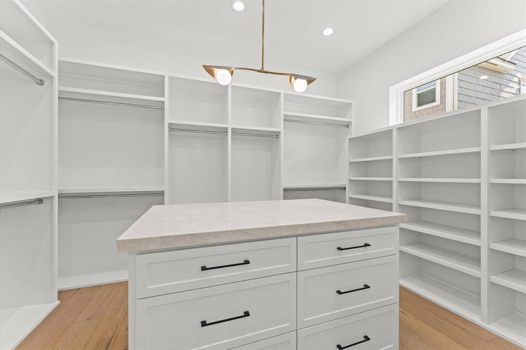Primary closet offers closet island.