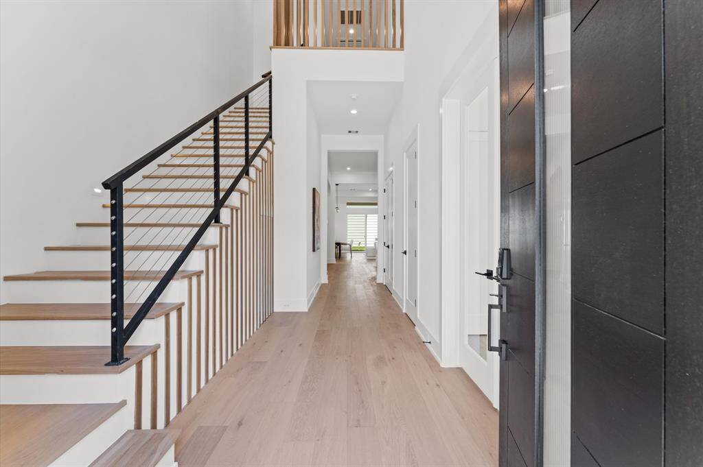 Home offers a bright and airy entry. With thoughtful touches such as hidden under air storage and stainless steel cable stair rail.