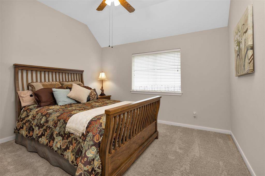 Experience the inviting charm of this spacious bedroom.