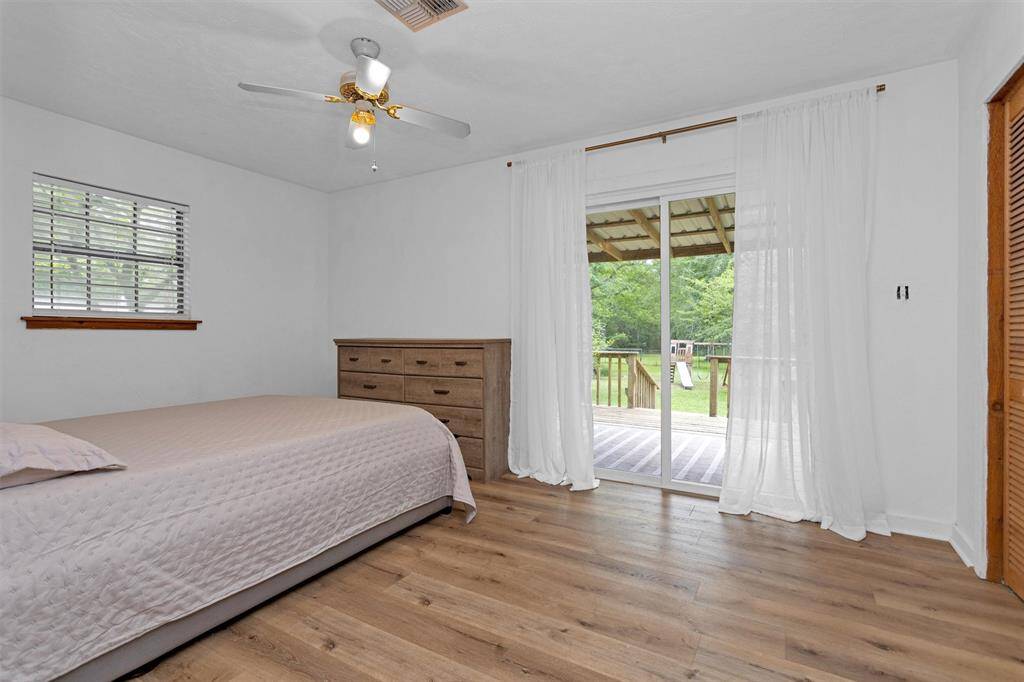 Comfortable primary bedroom with peaceful views of the surrounding acreage.