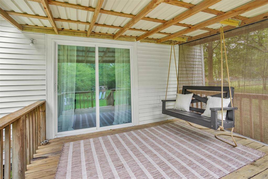 Spacious back porch perfect for enjoying peaceful mornings or quiet evenings surrounded by nature.