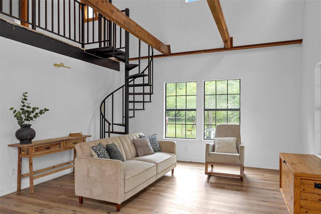 Cozy and inviting living area featuring cedar beams and warm wood accents throughout.