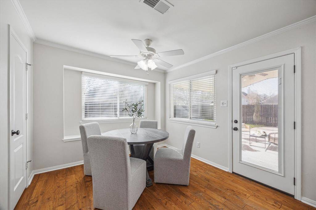 A charming breakfast nook area with tons of natural light overlooks the backyard oasis.