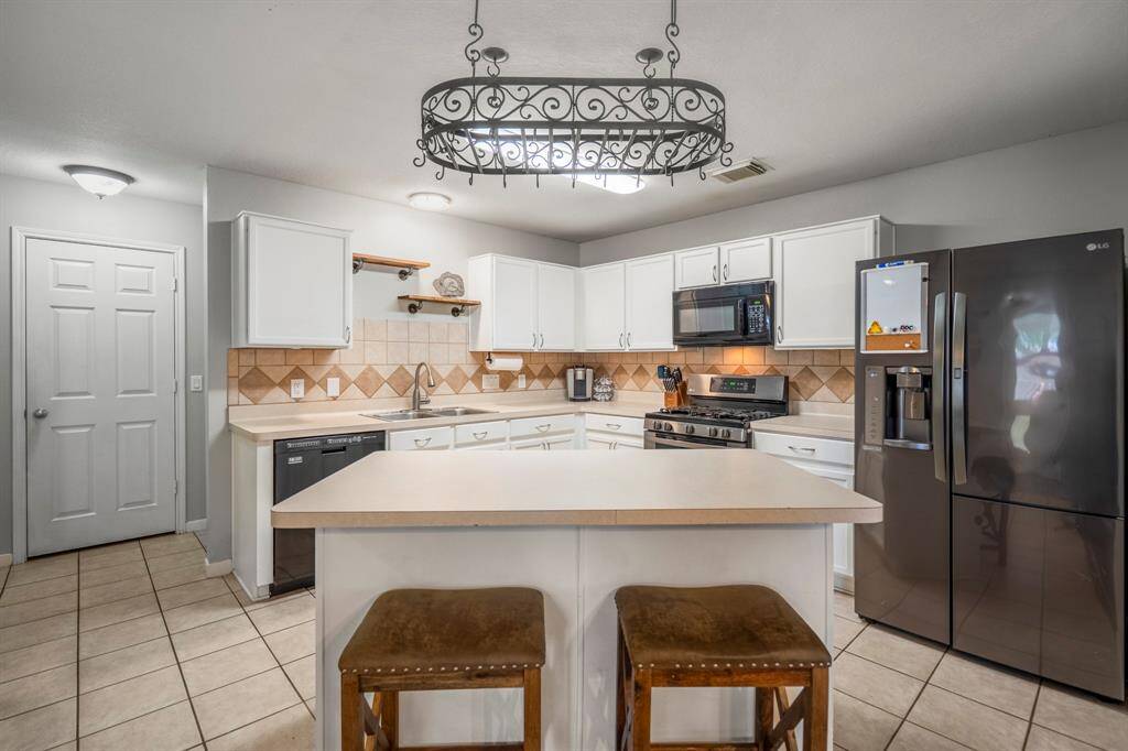 Gather around the spacious kitchen island, which provides additional seating and prep space.