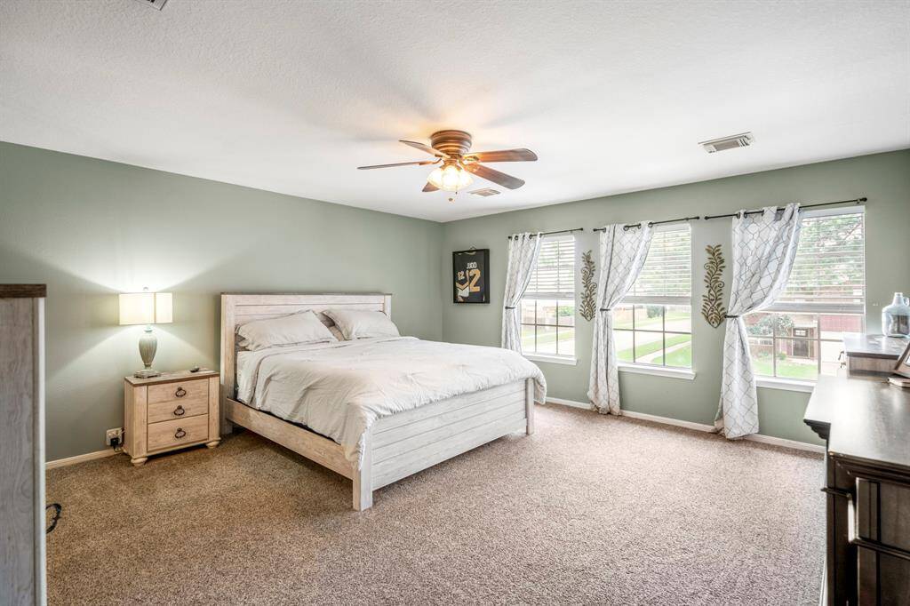 Step into this serene primary with large windows.