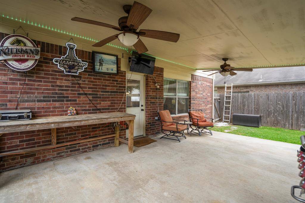 A wide-angle view of the covered patio highlights its perfect layout for socializing while enjoying nature.