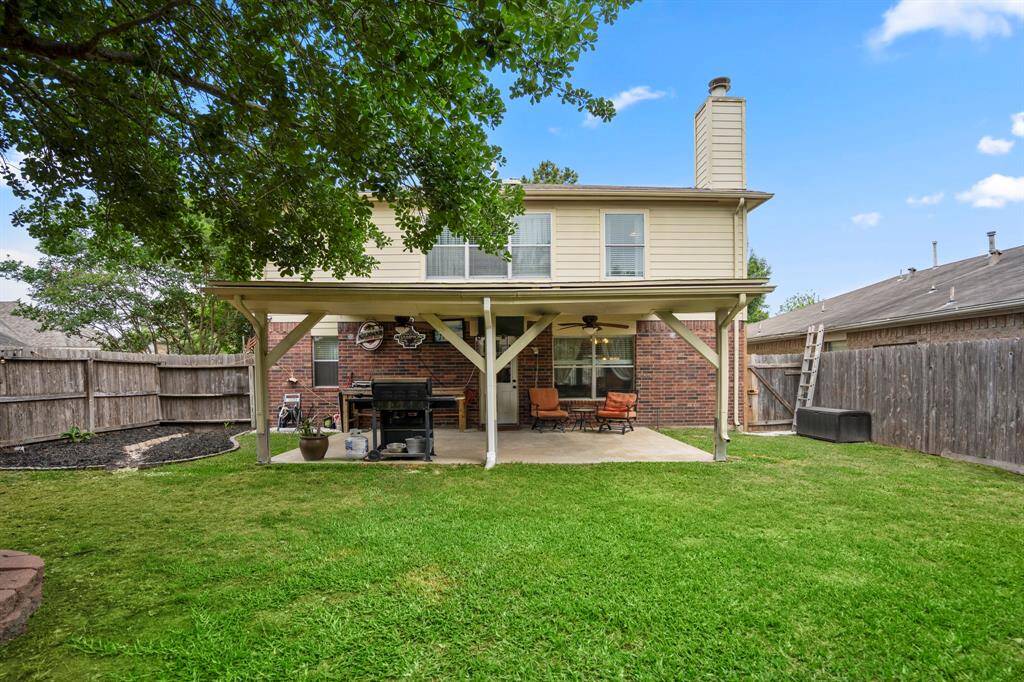 This exterior shot showcases the home's charming facade along with the expansive backyard.