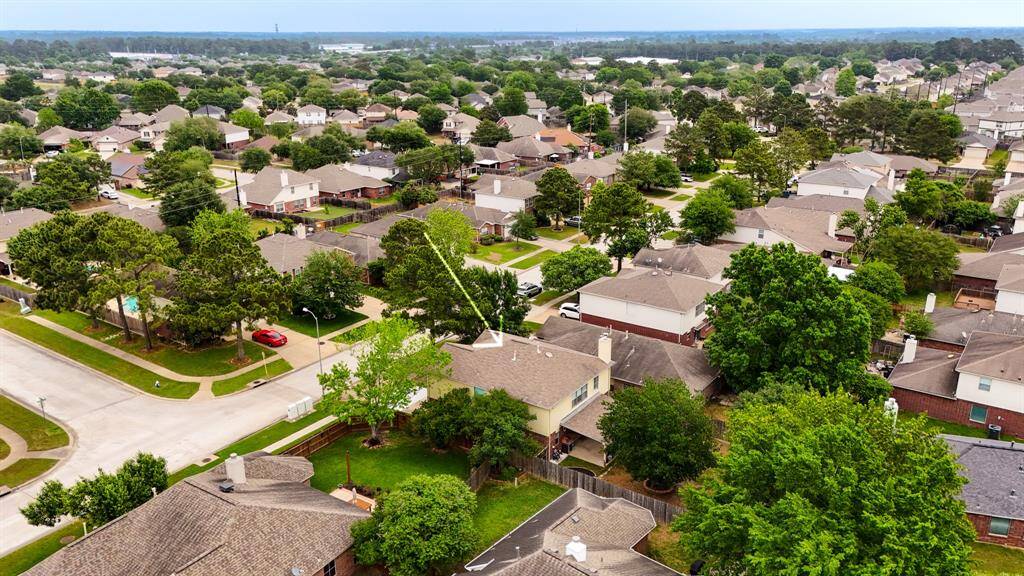 This aerial view showcases the surrounding neighborhood, highlighting its peaceful environment and community appeal.