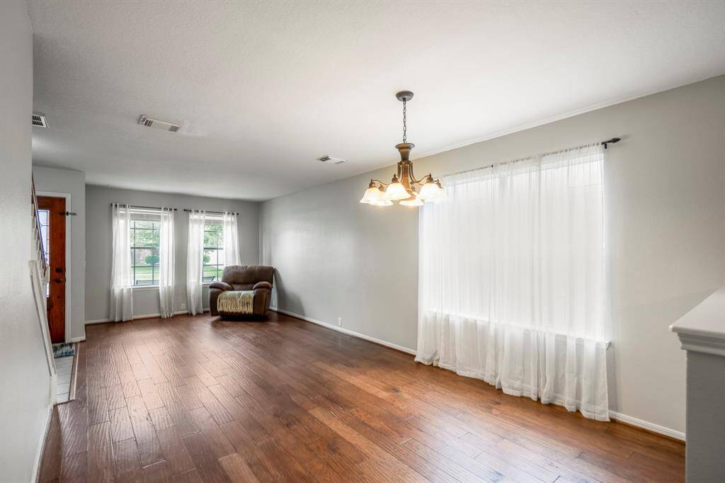 The family room offers ample space for gatherings. Its flexible layout allows for a variety of furniture arrangements.