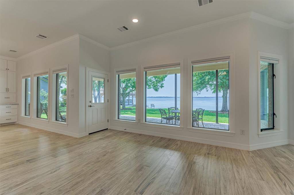 New energy efficient windows were installed along the rear of the home to maximize lake views and improve insulation. Custom shades offer the flexibility to raise or lower for both privacy and light control, allowing you to tailor the ambiance to your preference.