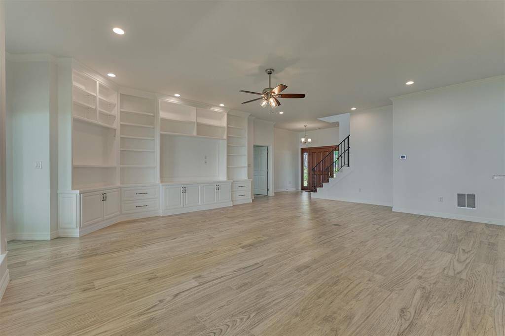 The custom built-in cabinetry is pre-wired for future lighting and TV installation, offering both functionality and flexibility. Throughout the home, you'll find solid wood trim—no MDF—painted with high-end finishes. The walls have been meticulously prepared with six layers of smooth float, creating a sleek, modern look with a flawless finish.