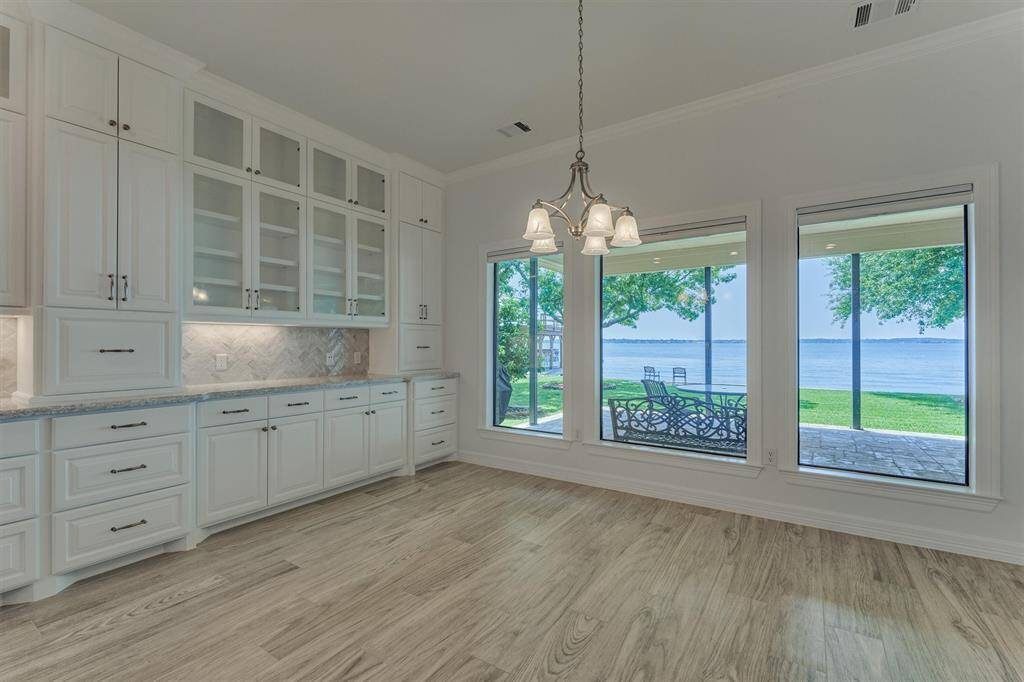 The back wall of the dining space was redesigned with large picture windows to maximize the lake views. These also have shades offering the flexibility to raise or lower for both privacy and light control.