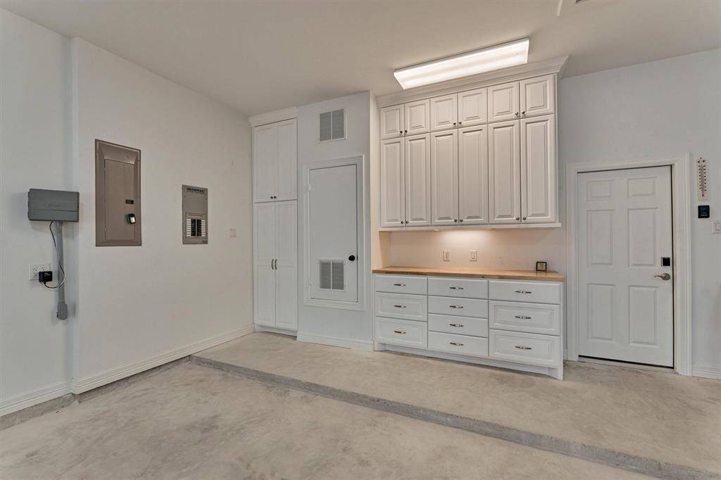 A closer look at the lighted work area reveals a durable wooden worktop and a variety of storage solutions, ideal for projects and organization. For a full list of upgrades, including extensive electrical and plumbing enhancements, please refer to the attached features sheet.