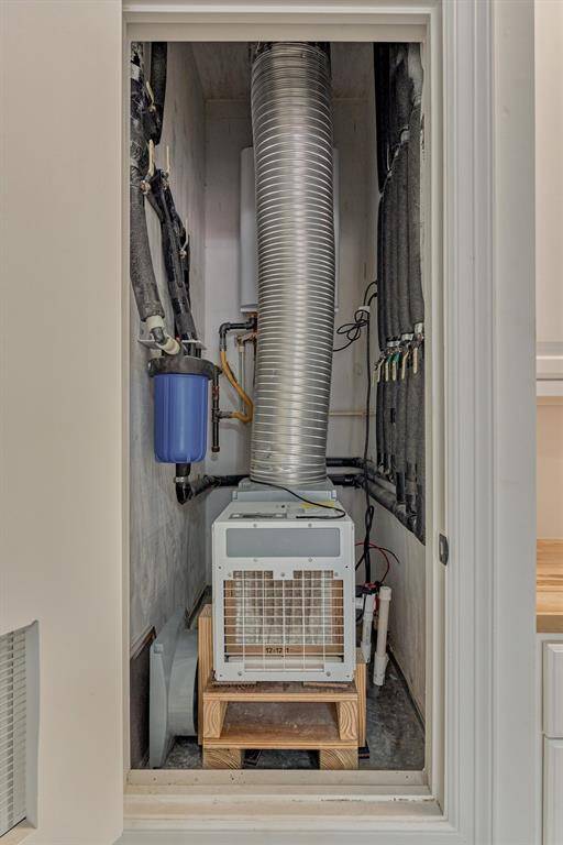 A dedicated dehumidifier in the garage closet helps maintain a climate-controlled environment, complemented by two filtered fresh air supply vents that ensure proper airflow and improved air quality.