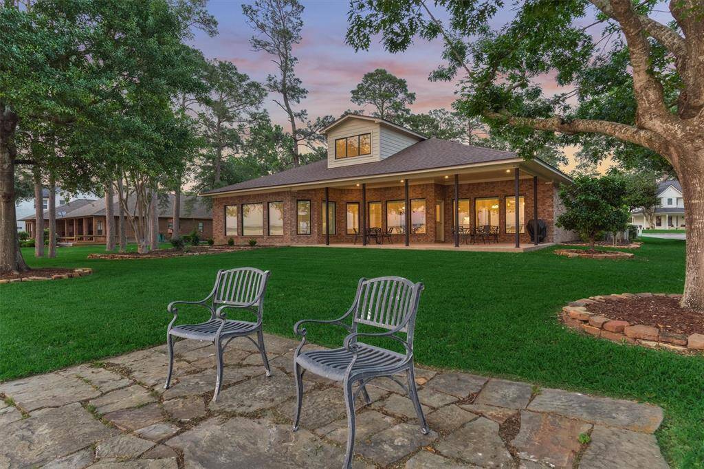 The back of the home is beautifully lit at night, creating a warm and inviting ambiance. The landscape has been professionally graded for optimal drainage, and an eight-zone sprinkler system—sprinkler controller enclosure is pre wired for cat 6 future sprinkler controller—ensures the lush greenery stays perfectly watered year-round.