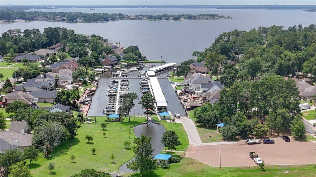 The gated community of Point Aquarius offers direct access to Lake Conroe with a private boat ramp and a marina for convenient boat storage, making it easy to enjoy lakeside living and water activities year-round.